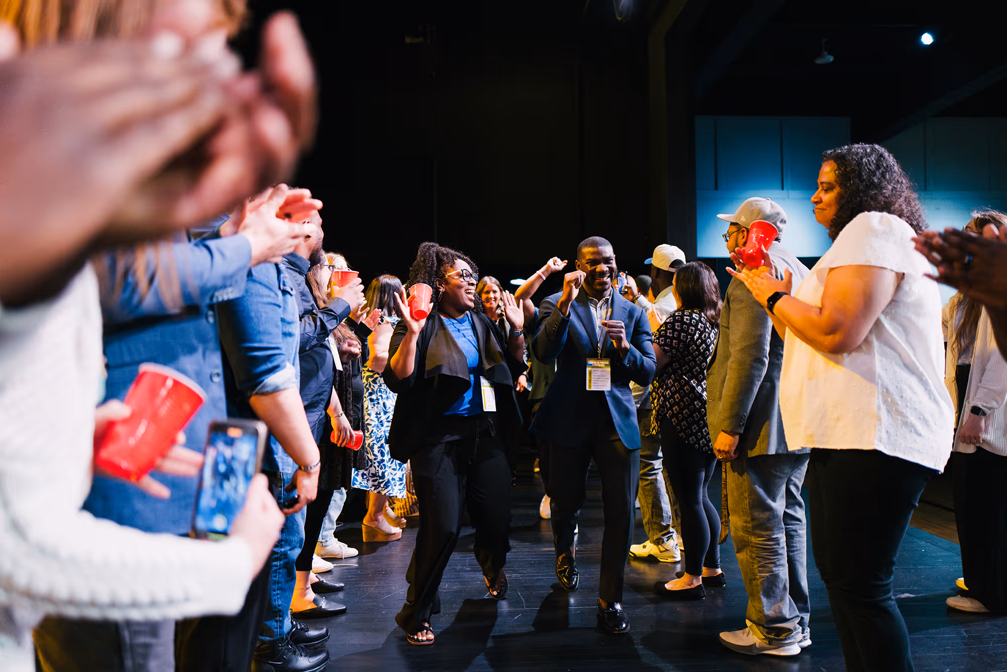 A group of people standing around each other.