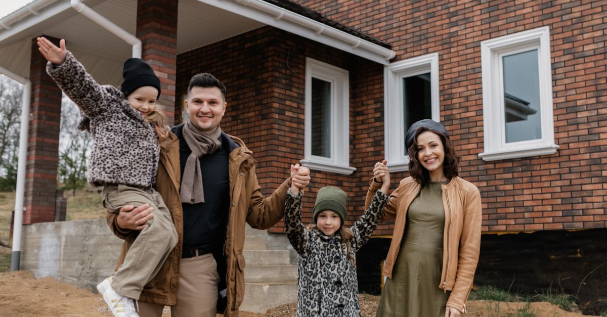 A family standing in front of their home — mortgage protection insurance from The Admirals Group in Denton, TX