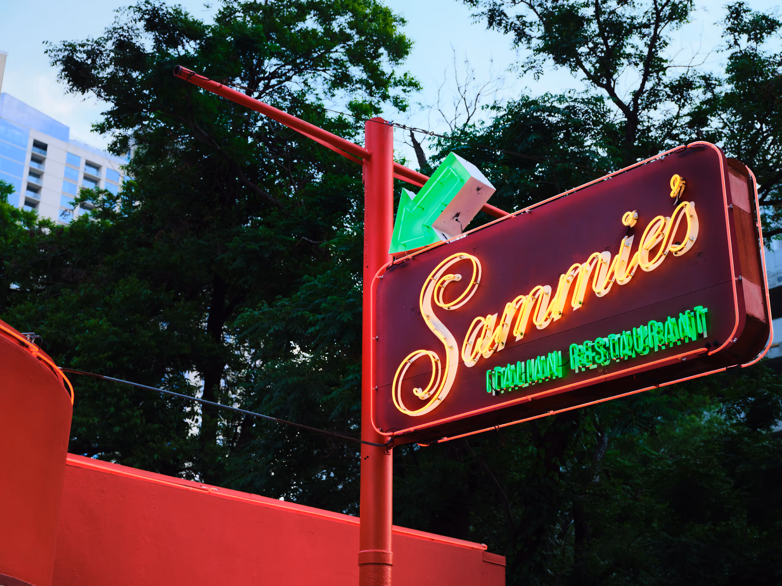 Sammie’s Italian Restaurant neon sign above the red exterior wall.