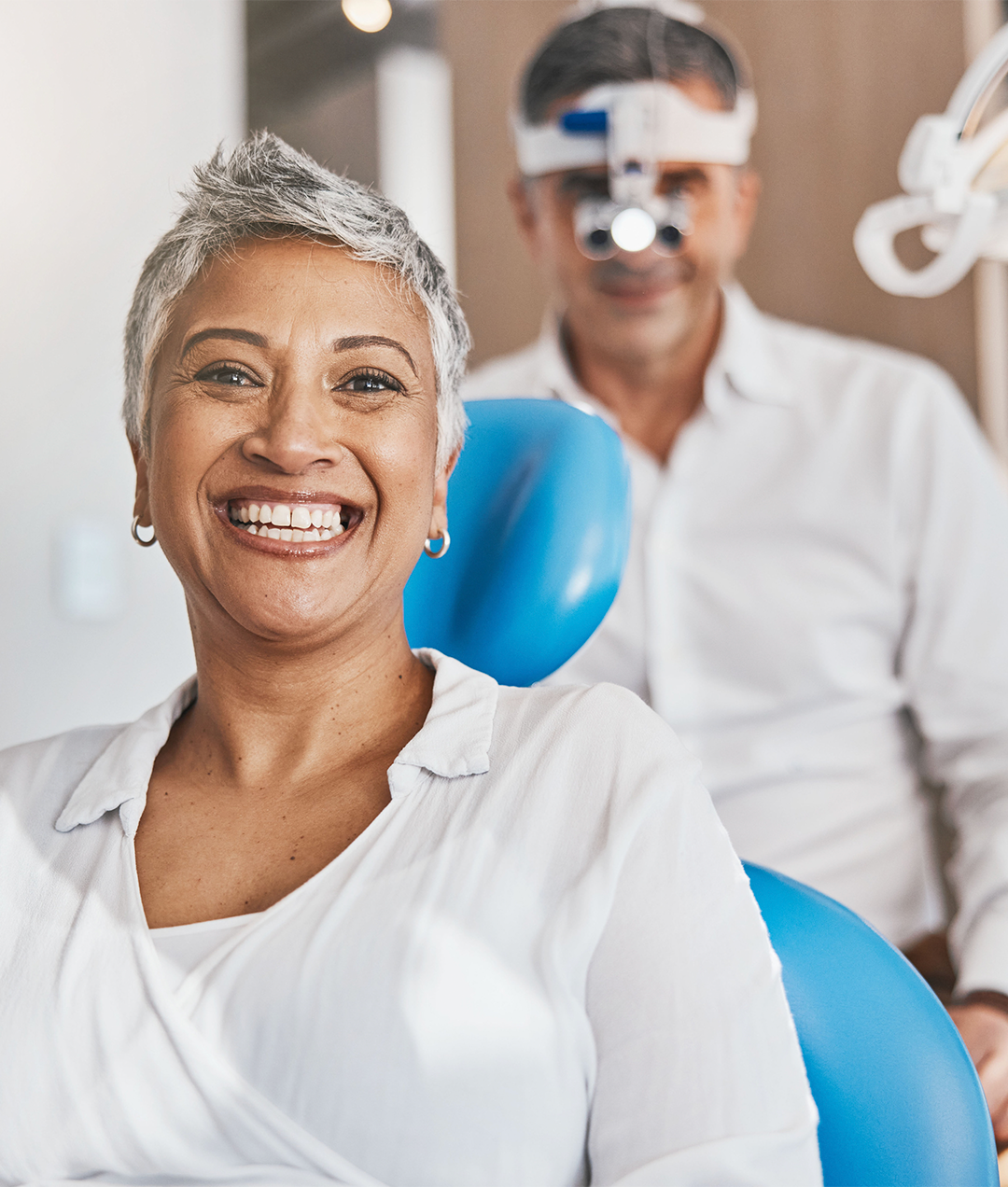 Smiling lady sitting in a dental chair