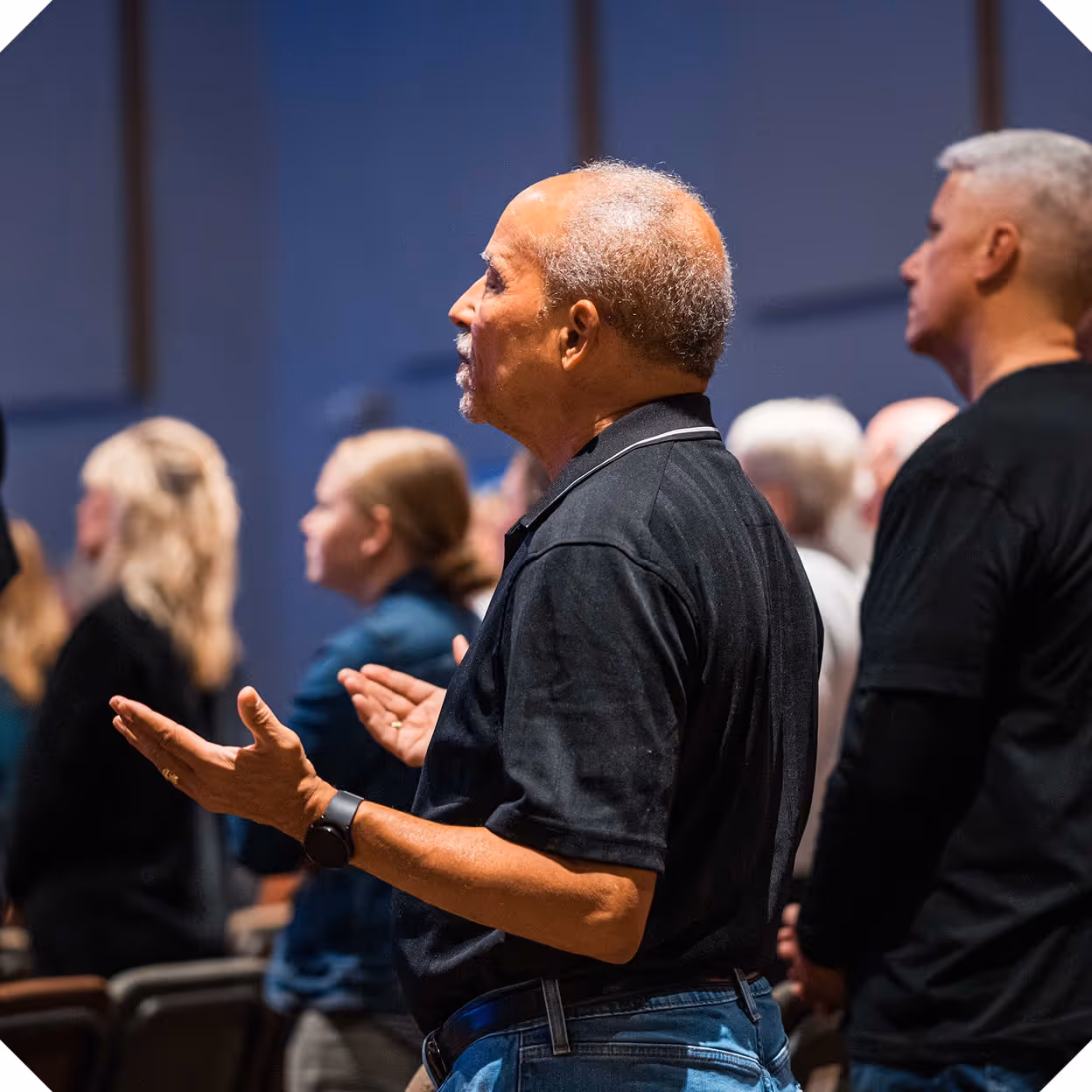 A man with his arms raised in worship