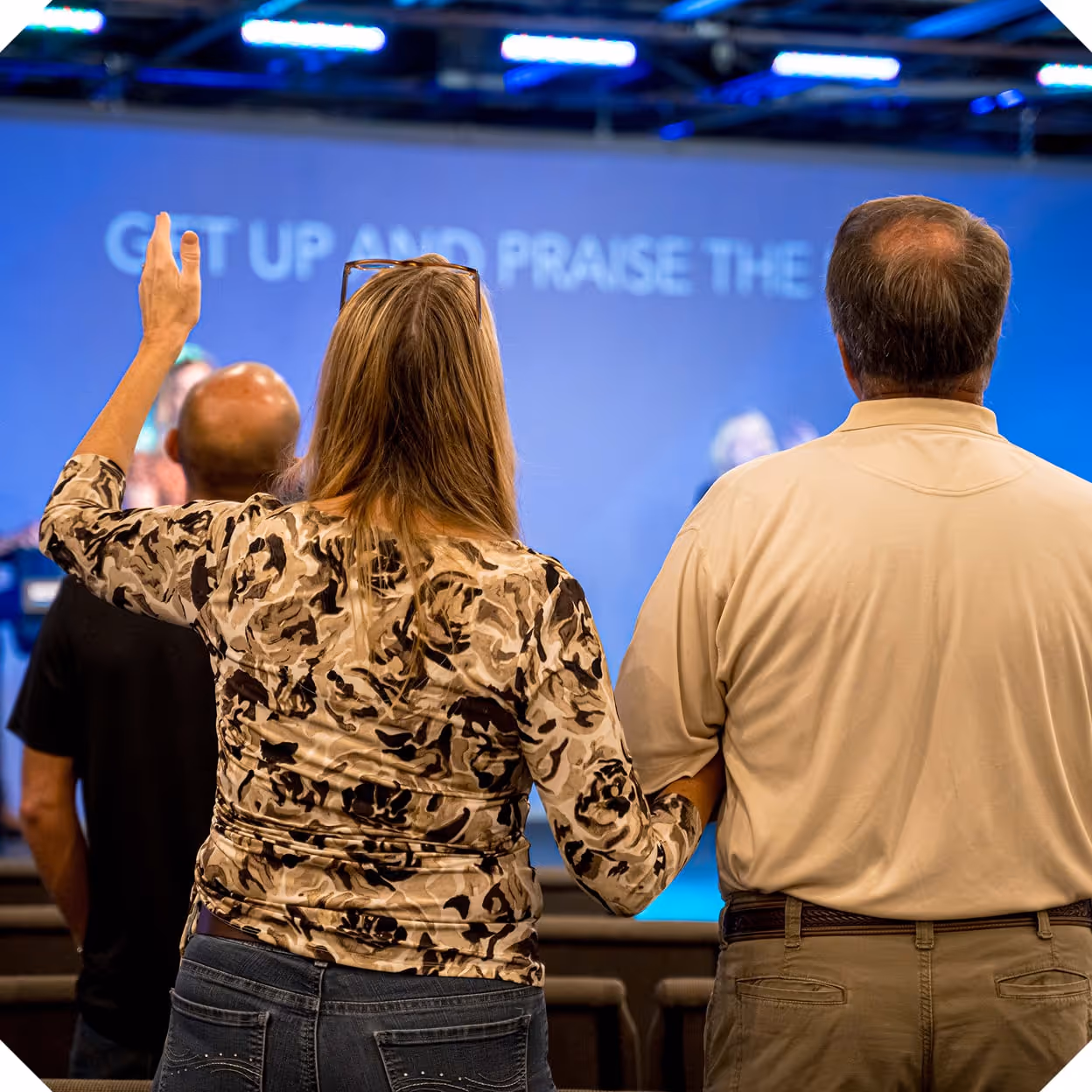 A couple holding hands during worship