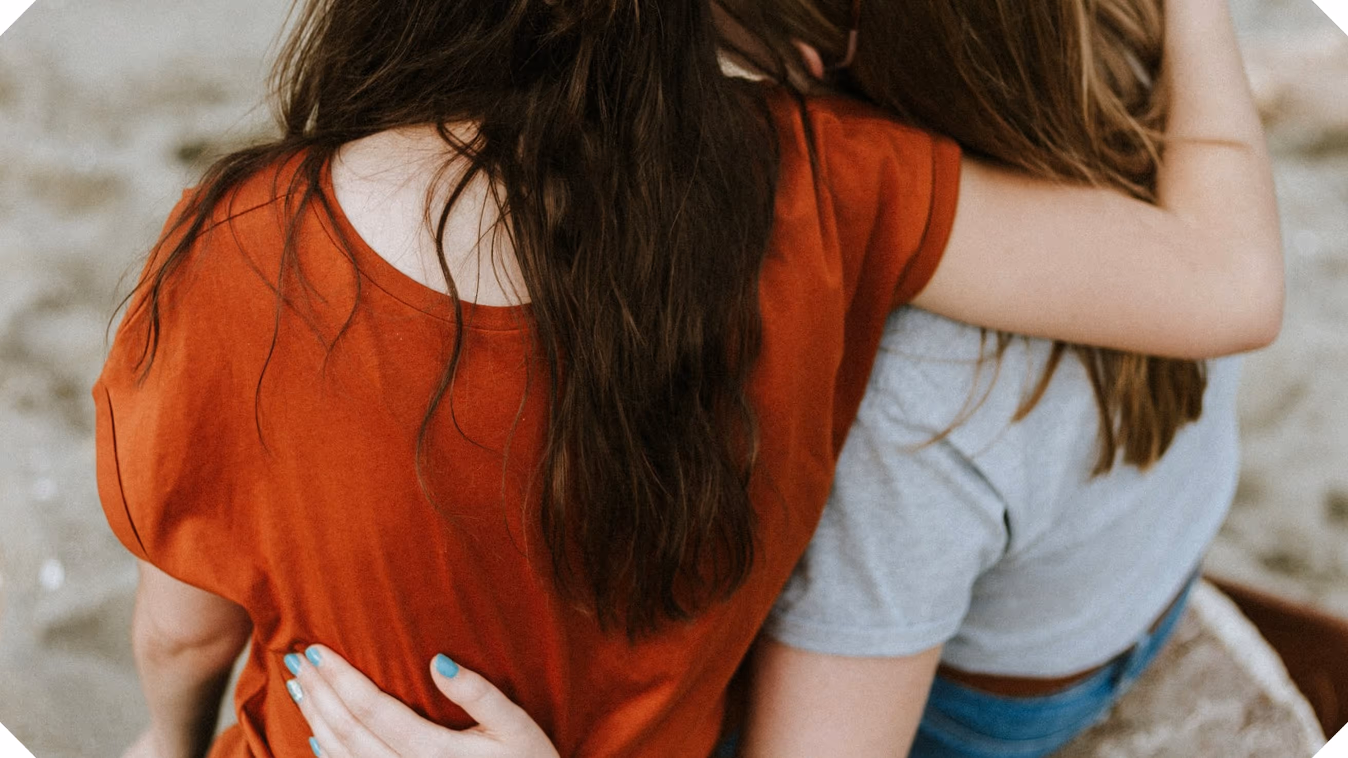 two women hugging each other