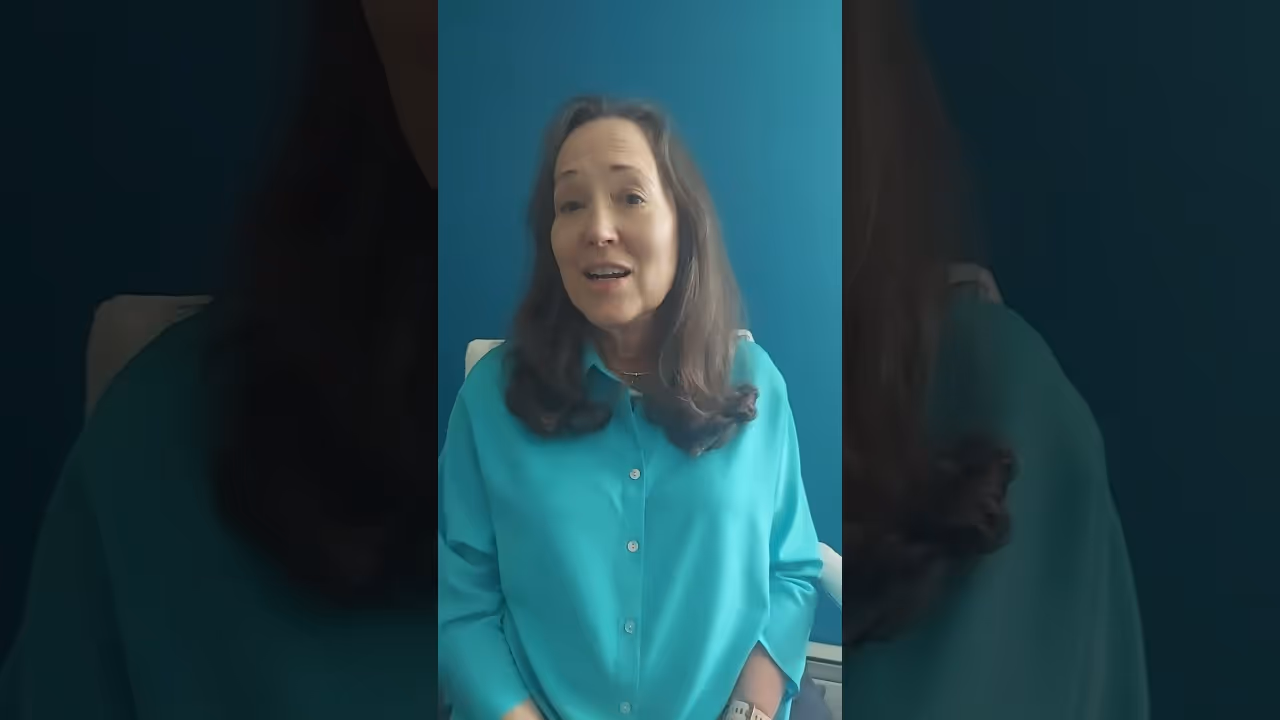 a woman in a blue shirt sharing her experience