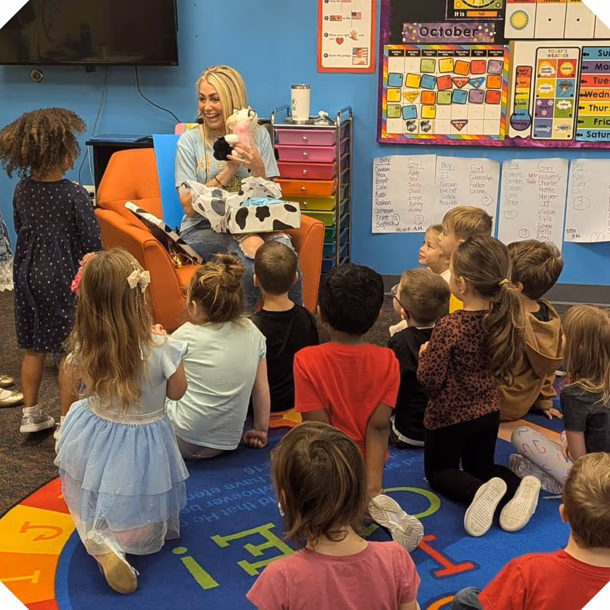 a group of children sitting on the floor in a classroom
