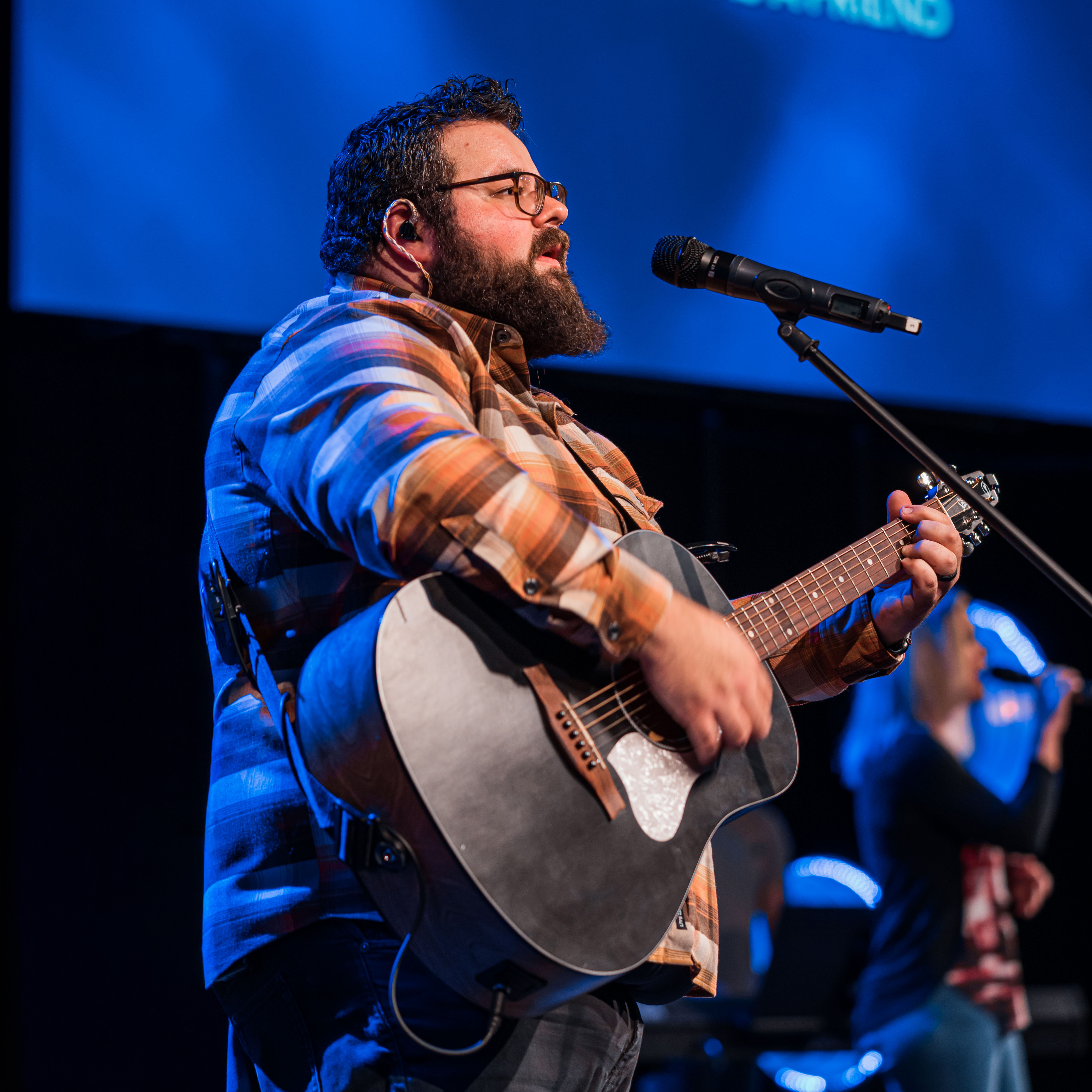 A singer and his guitar leading worship
