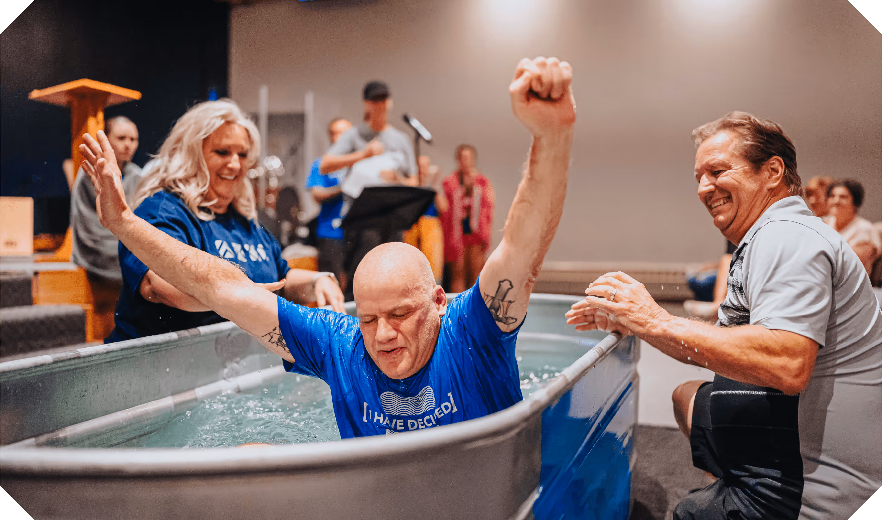 A man celebrating emerging from the waters after baptism
