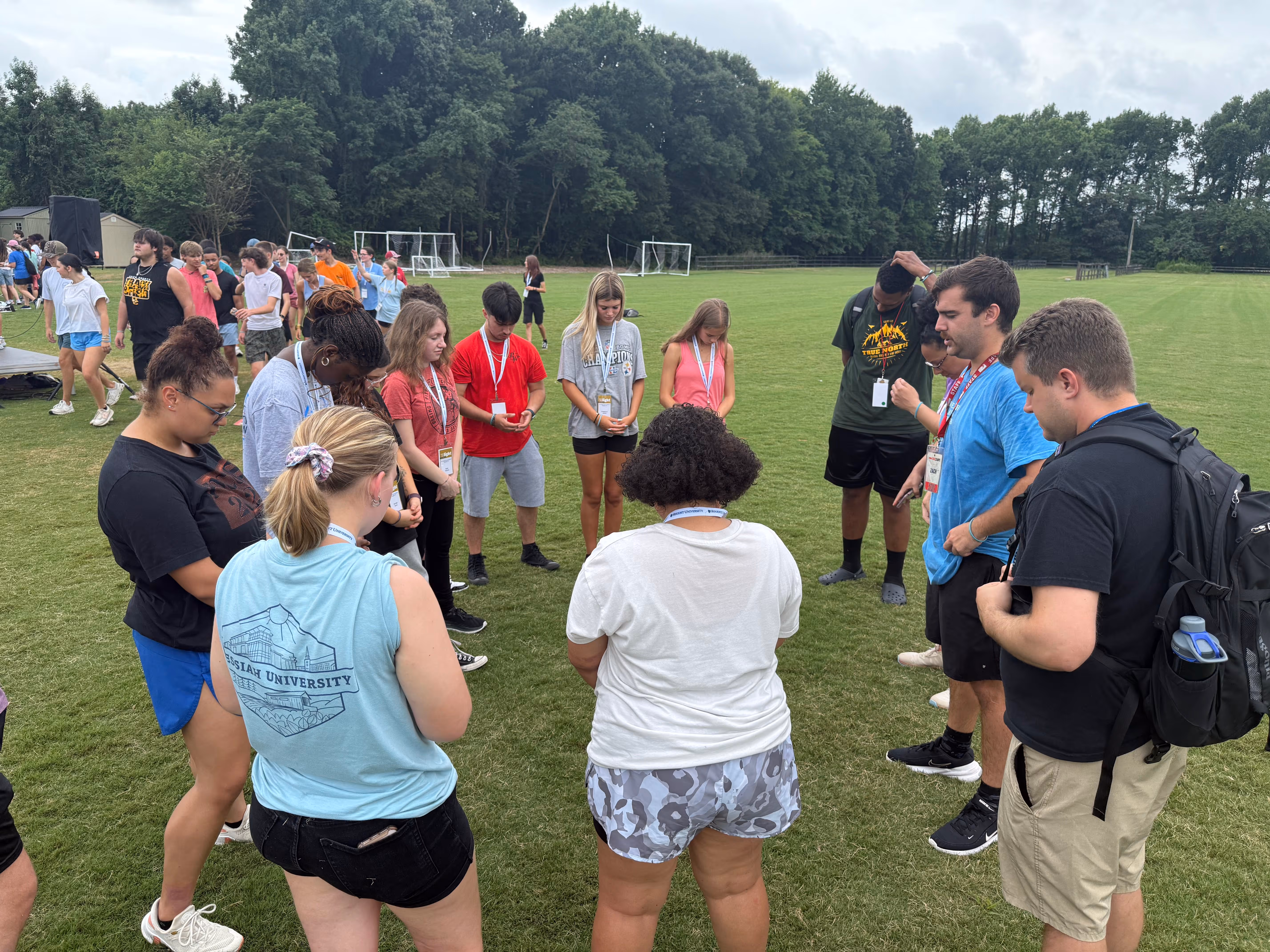 Students gathered in a prayer circle