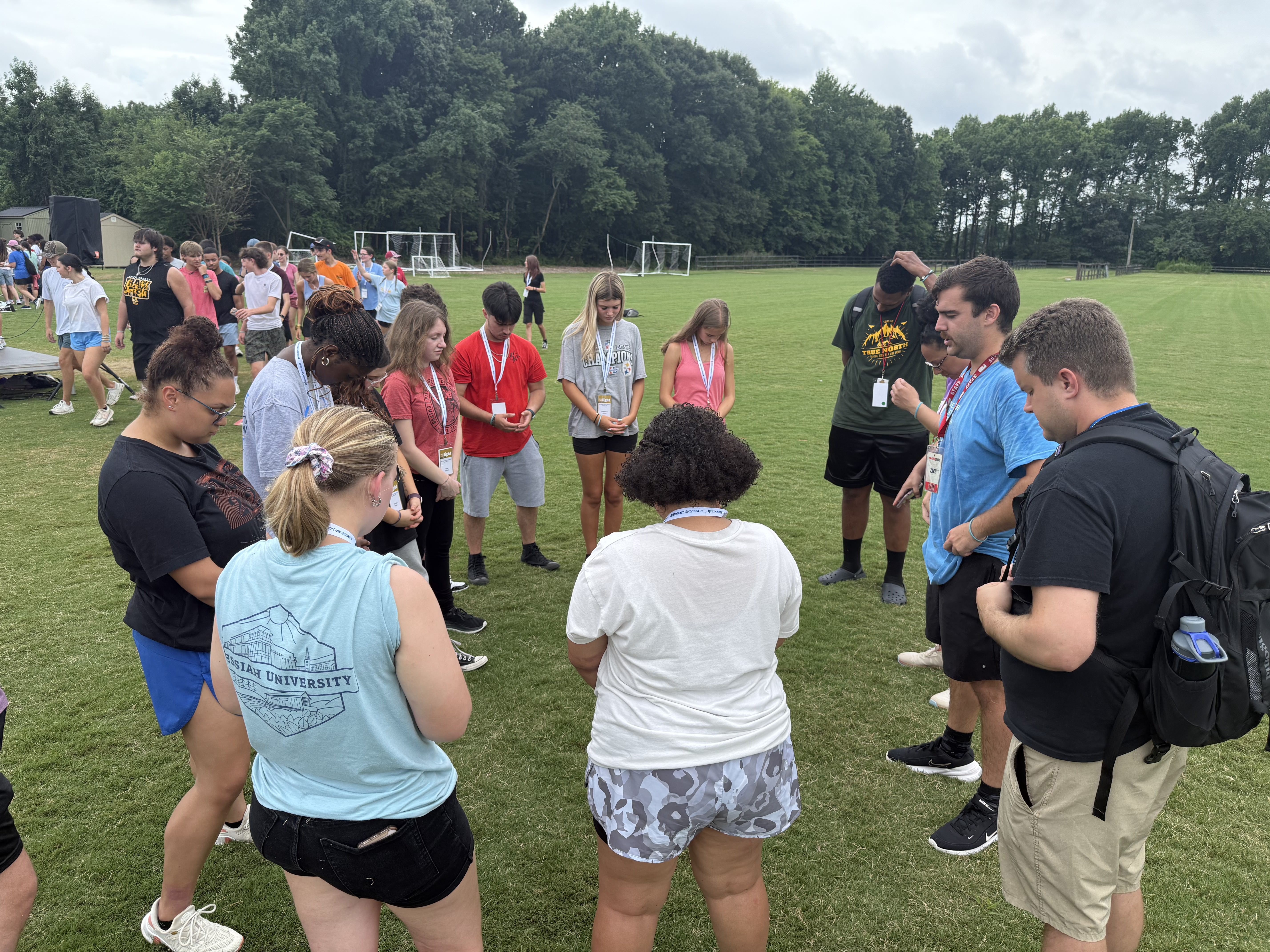 Students gathered in a prayer circle