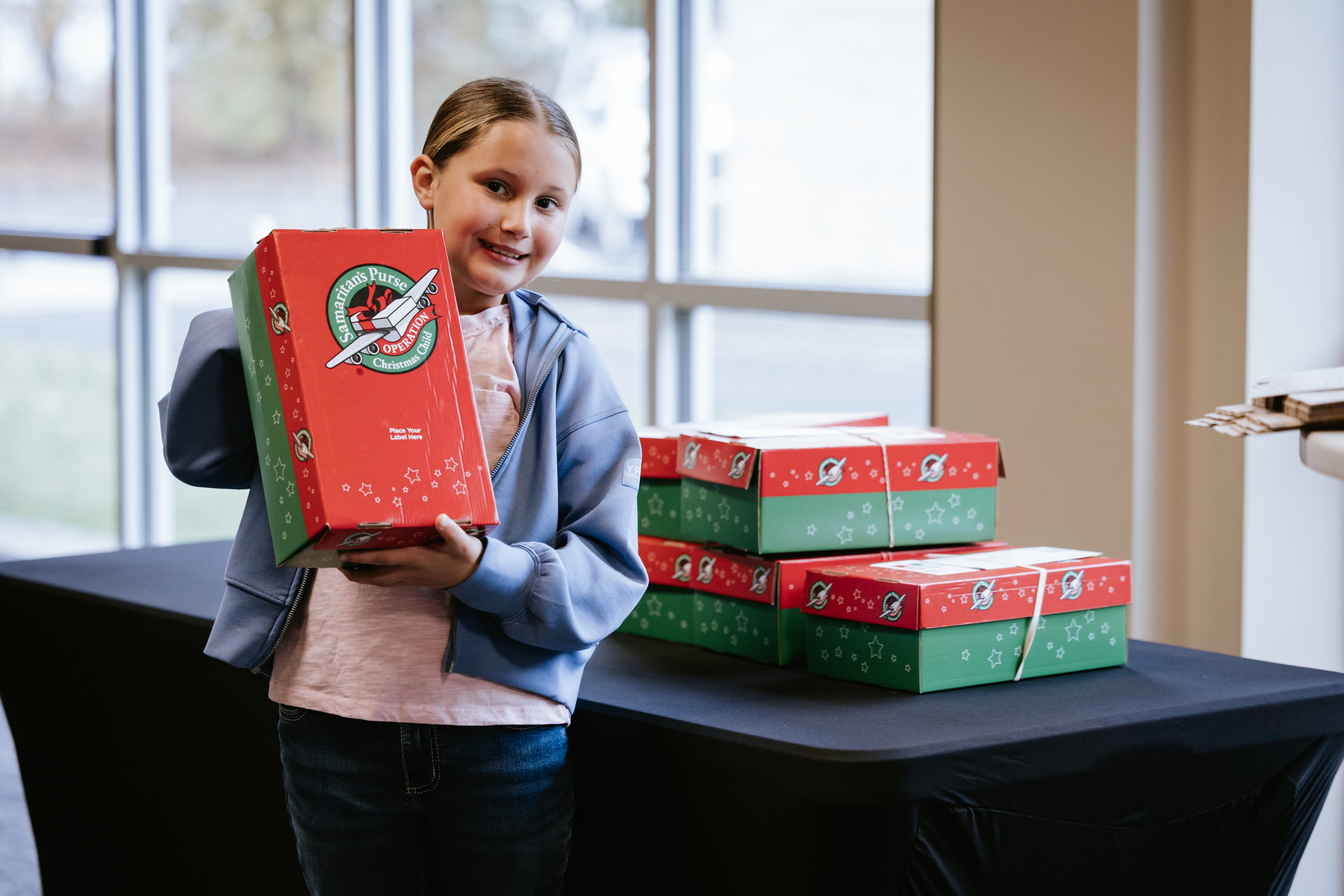 Girl holds an OCC box