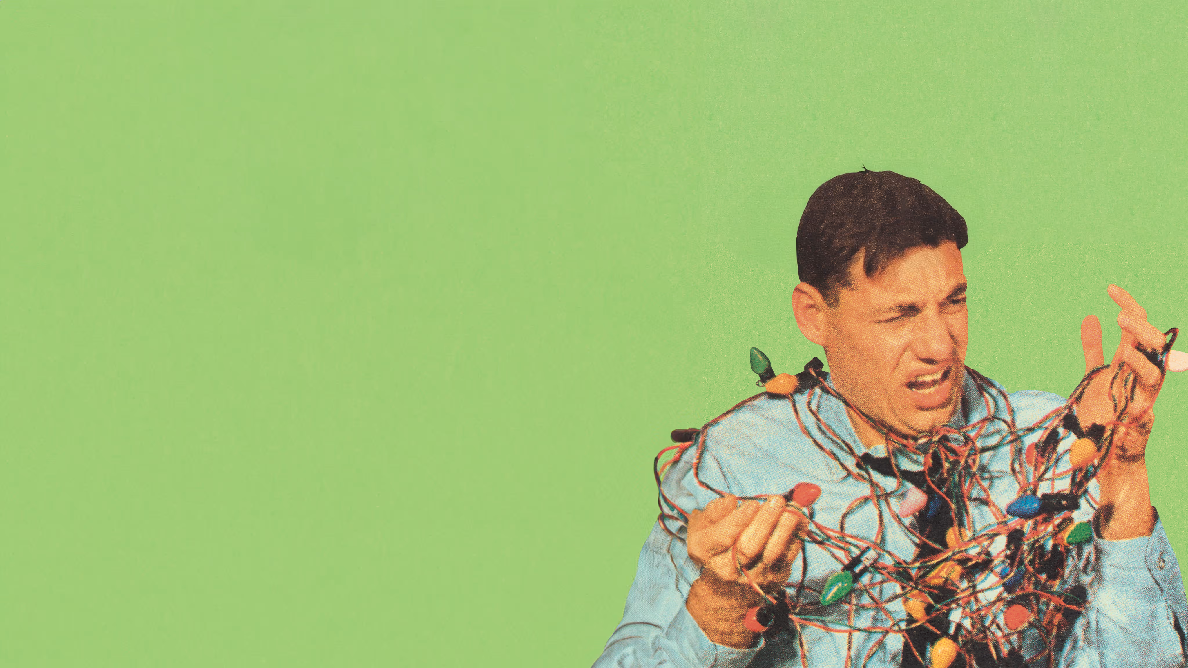 Man frustrated and tangled in colorful Christmas lights against a green background.