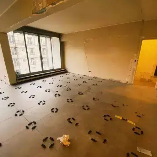 Empty room with footprints scattered across the floor near window