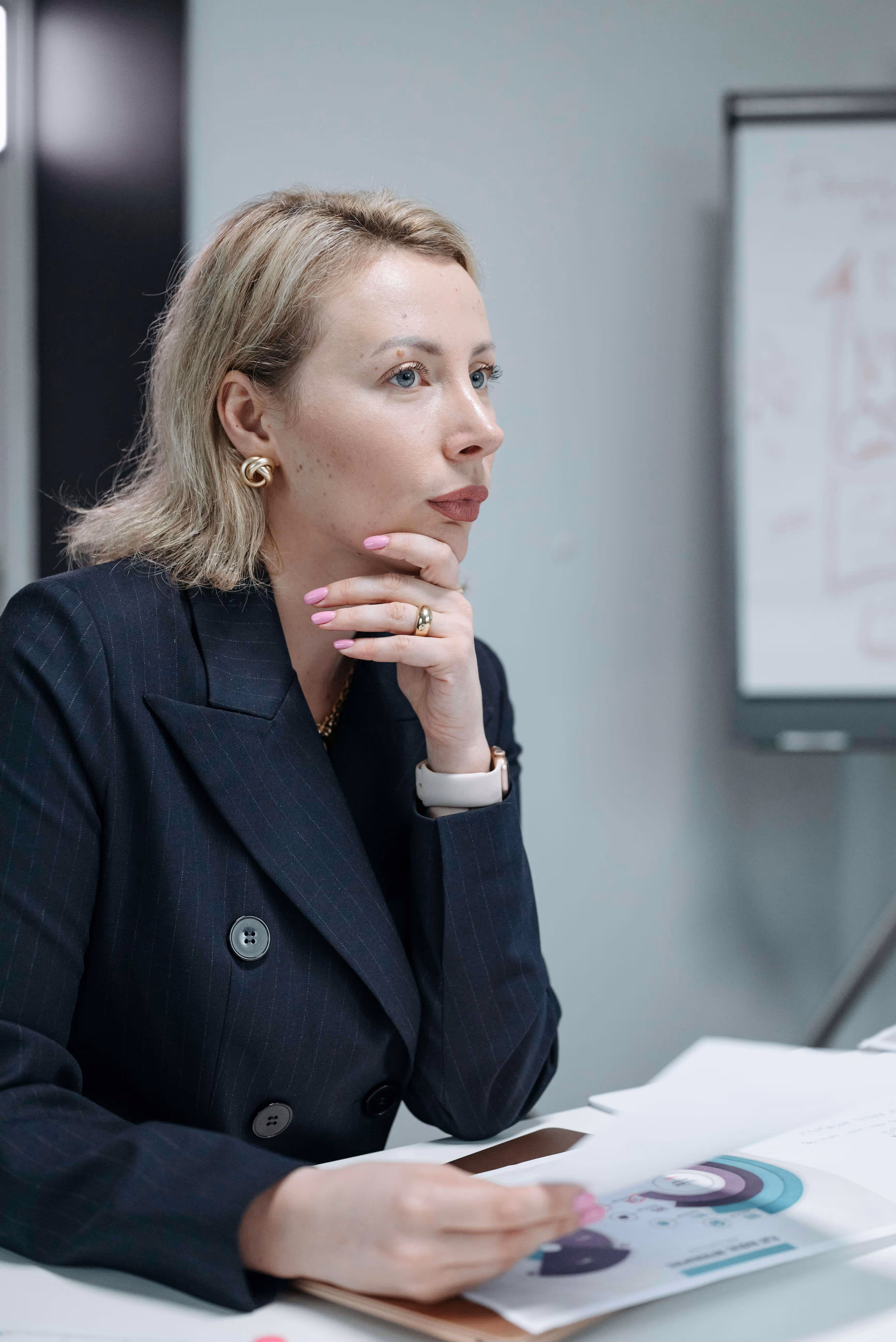 A professional woman contemplating the improvements needed for her business.