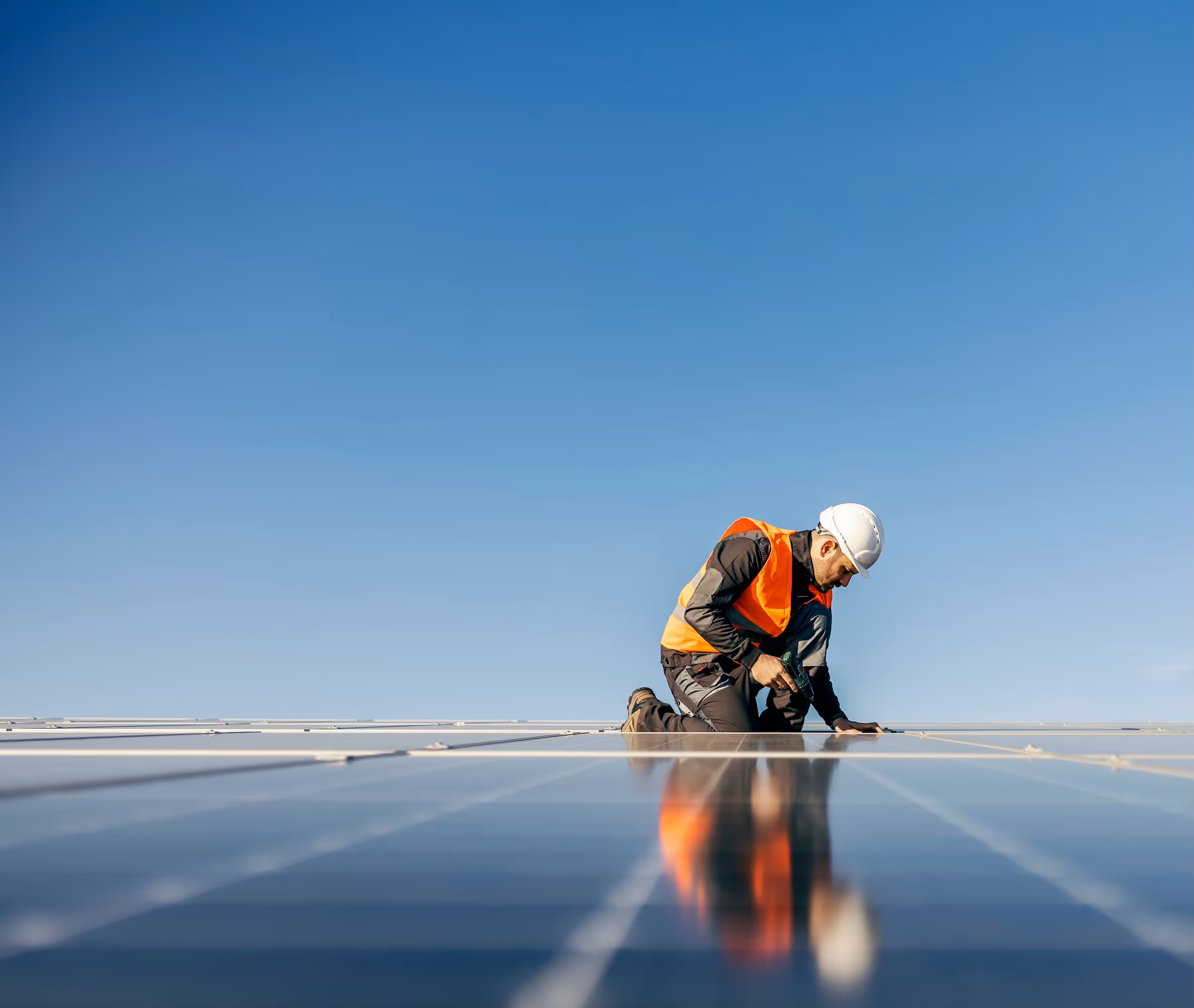 a worker working on a solar panel