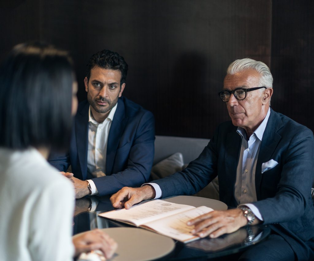 Co-owners reviewing agreement documents with legal counsel