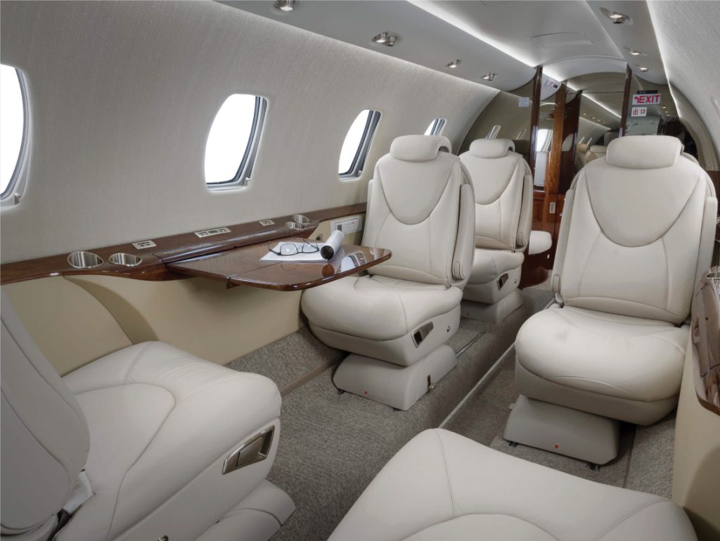 Private jet in flight above a coastline