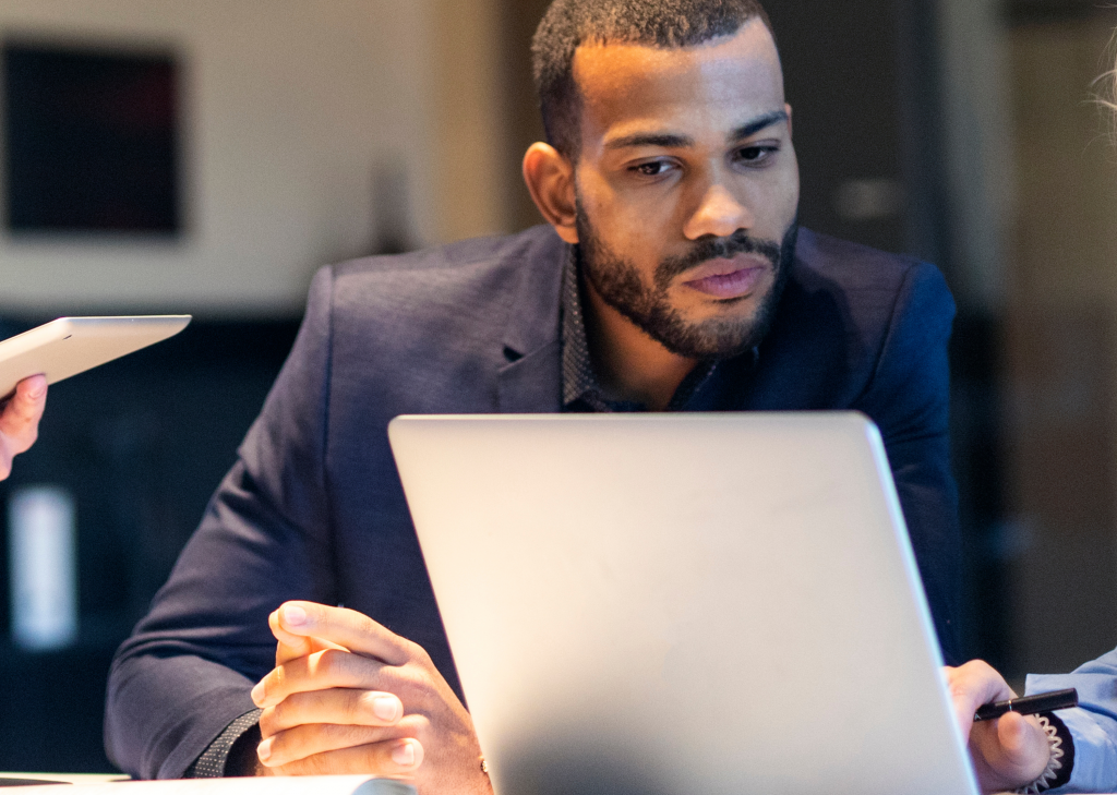 Manager reviewing candidate options on a laptop