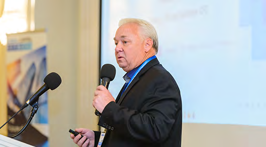 Speaker presenting on the main stage at a GCN investor conference