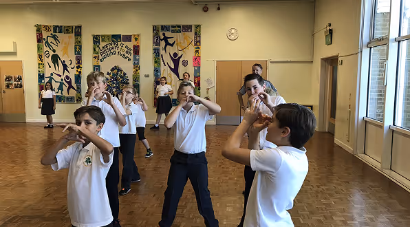 Group of students enjoying a high-energy dance session during a Dance Days school workshop.

