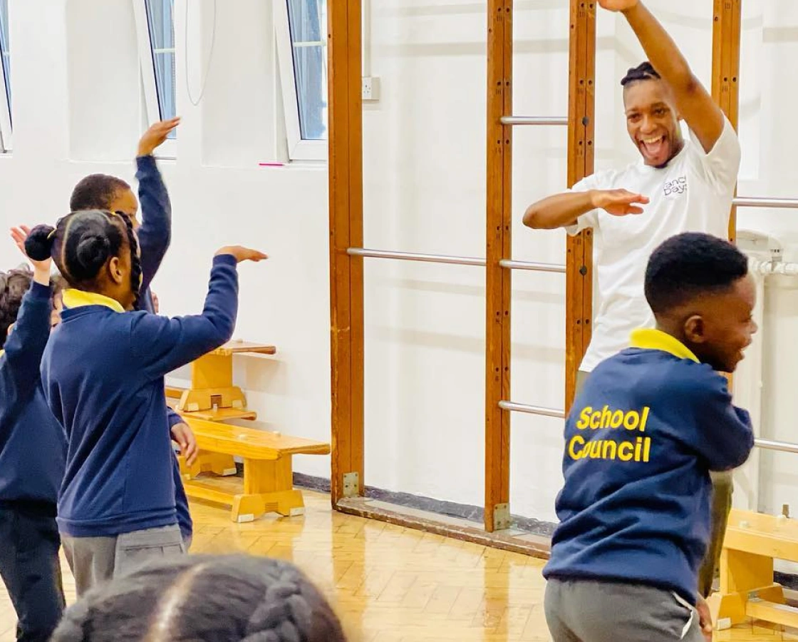 Group of students from various year groups participating in a dance workshop, highlighting inclusivity for all school ages.