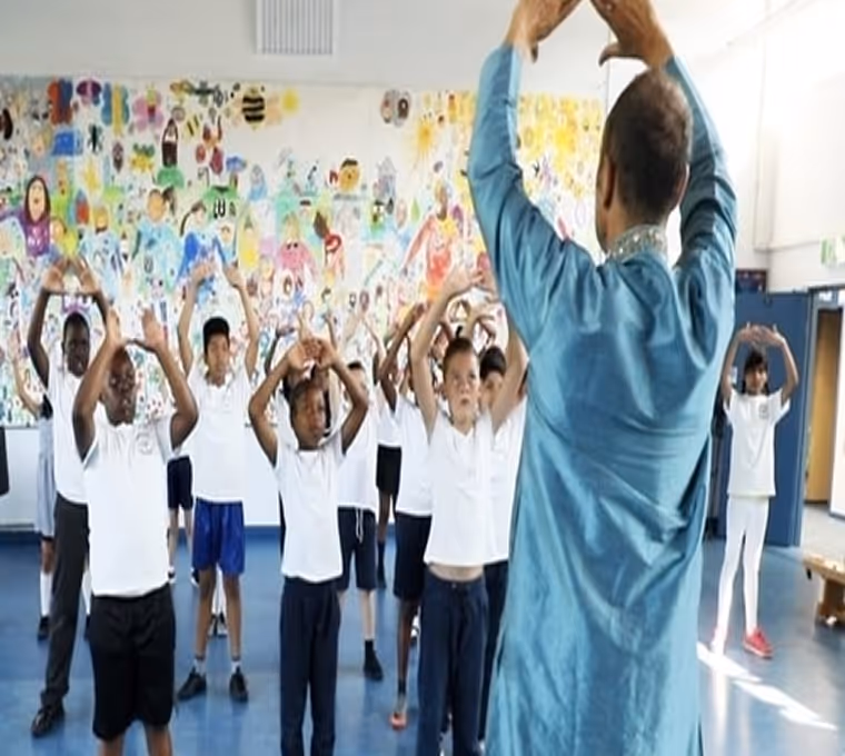 School children participating in a lively dance workshop, building confidence and teamwork through dance.