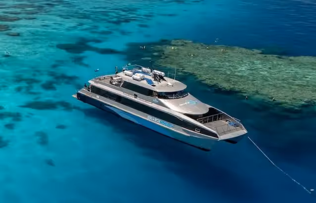 Silversonic moored near vibrant coral reefs in clear blue tropical waters.