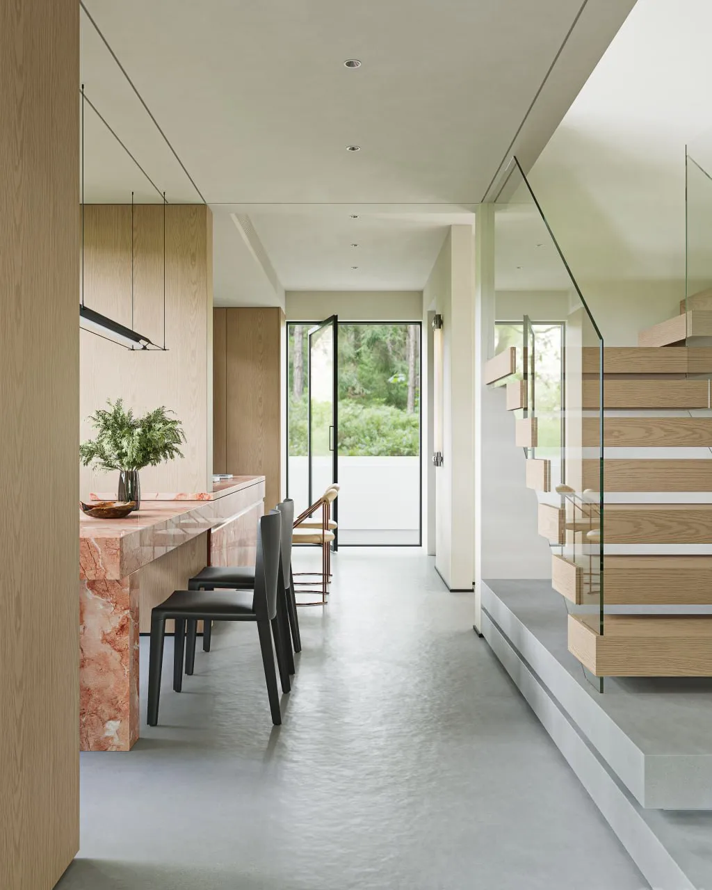 Modern interior with a marble countertop bar, black chairs, wooden staircase with glass railing, and an open door leading outside.