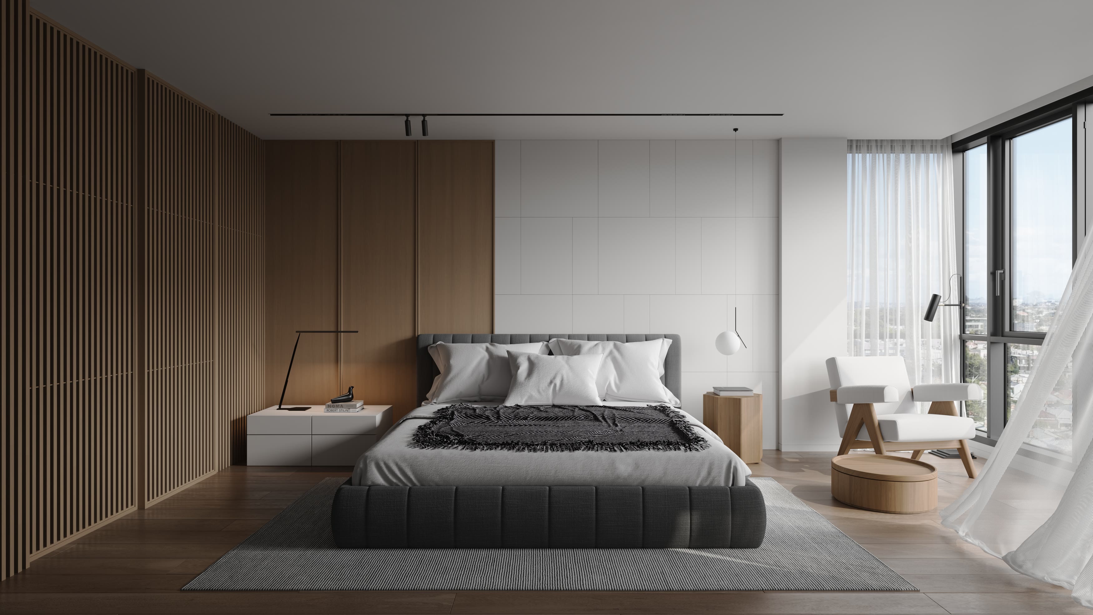 Bedroom with timber slat joinery, a grey upholstered bed and a white armchair beside tall corner windows.