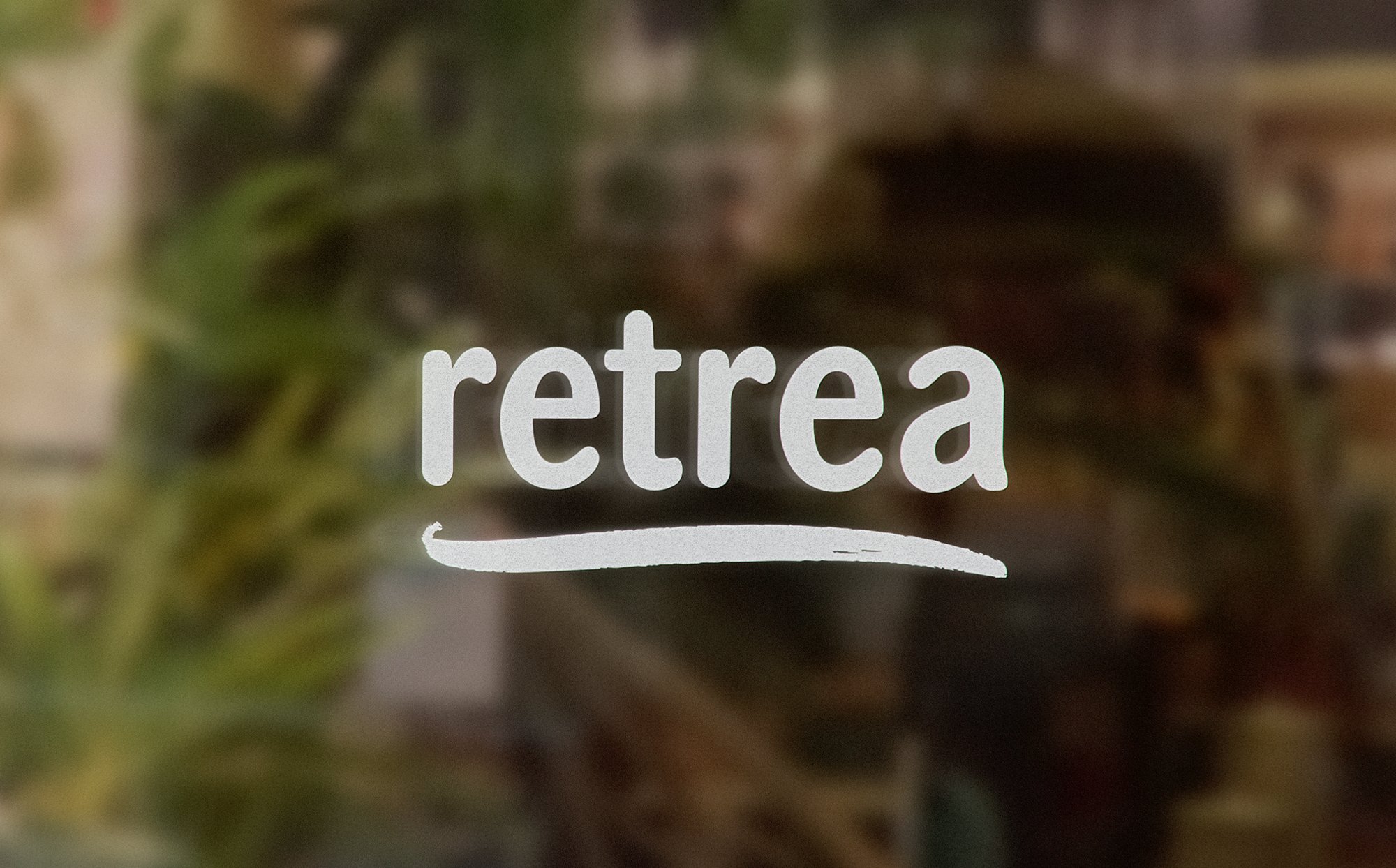 Retrea’s white lowercase wordmark and curved underline over a softly blurred green background.