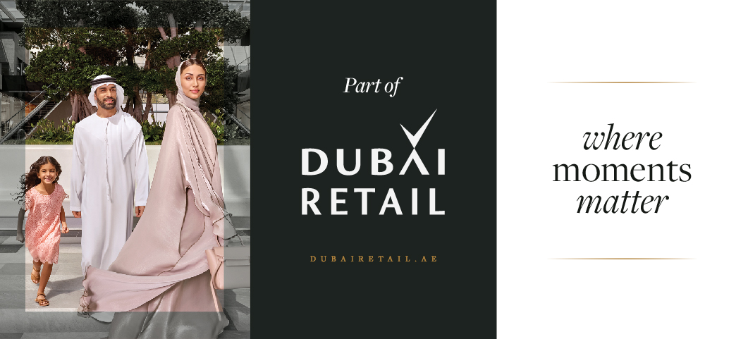 A family walking through a modern outdoor shopping plaza; text reads "Part of Dubai Retail."