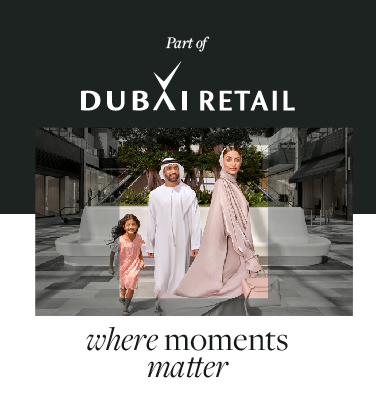 A family walking through a modern outdoor shopping plaza; text reads "Part of Dubai Retail."