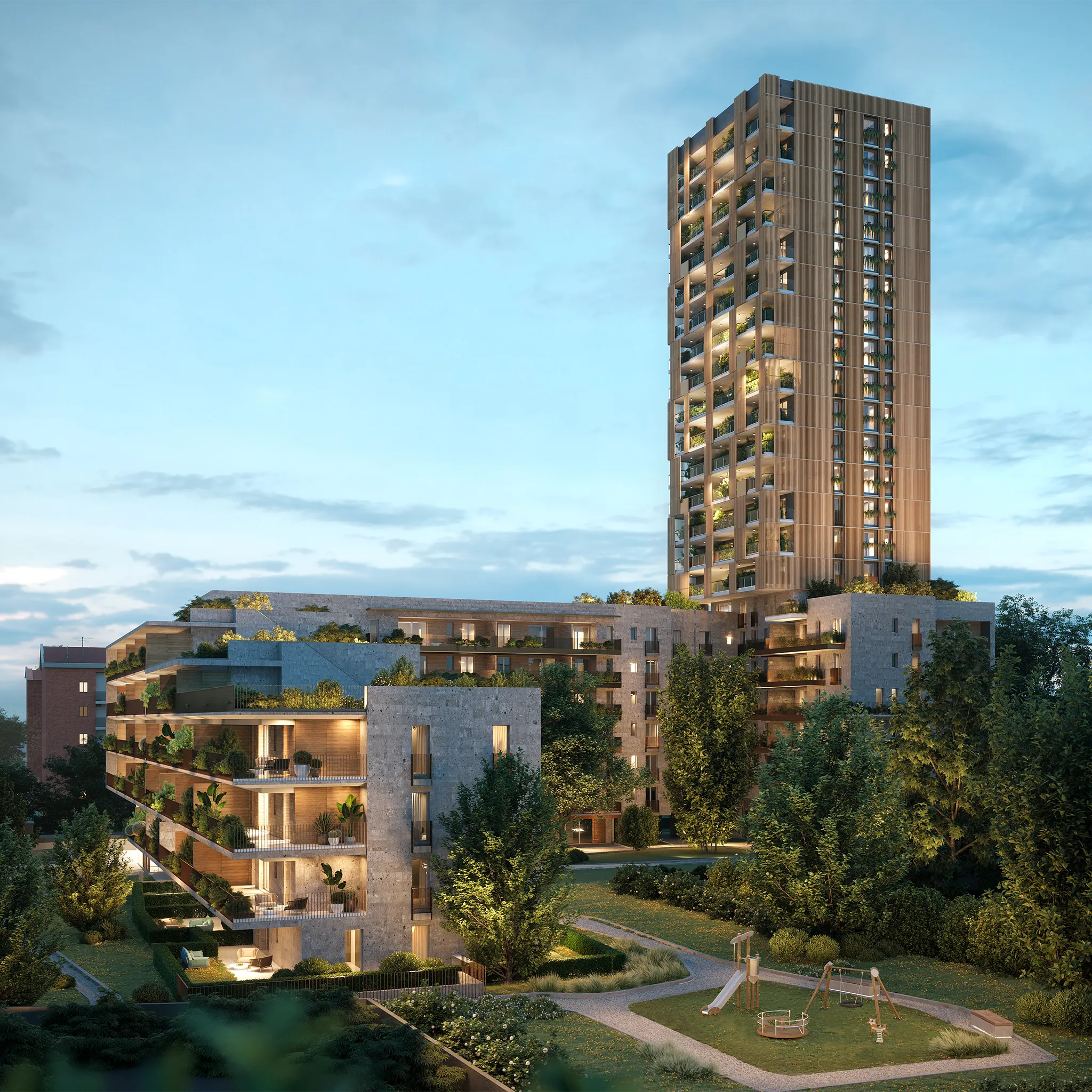 Complesso residenziale moderno con edifici alti e bassi circondati da alberi e area giochi all'aperto illuminata al tramonto.