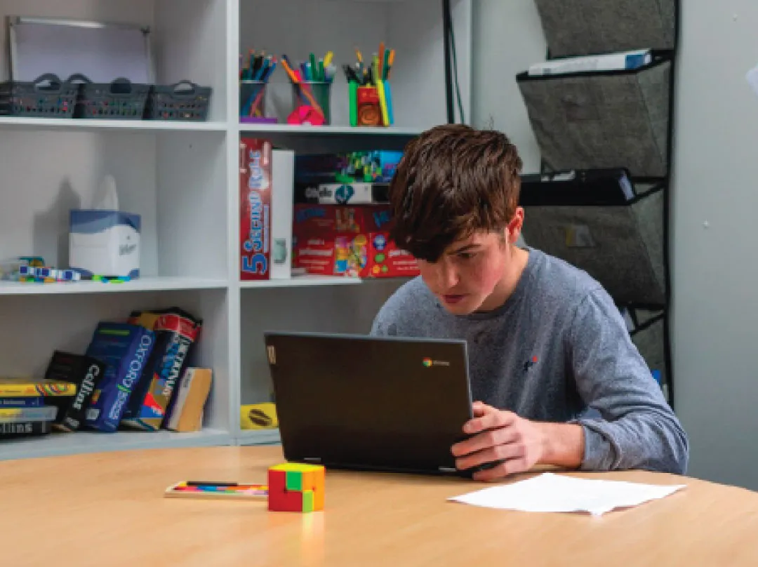 Bridge School Malvern - Pupil working on laptop 
