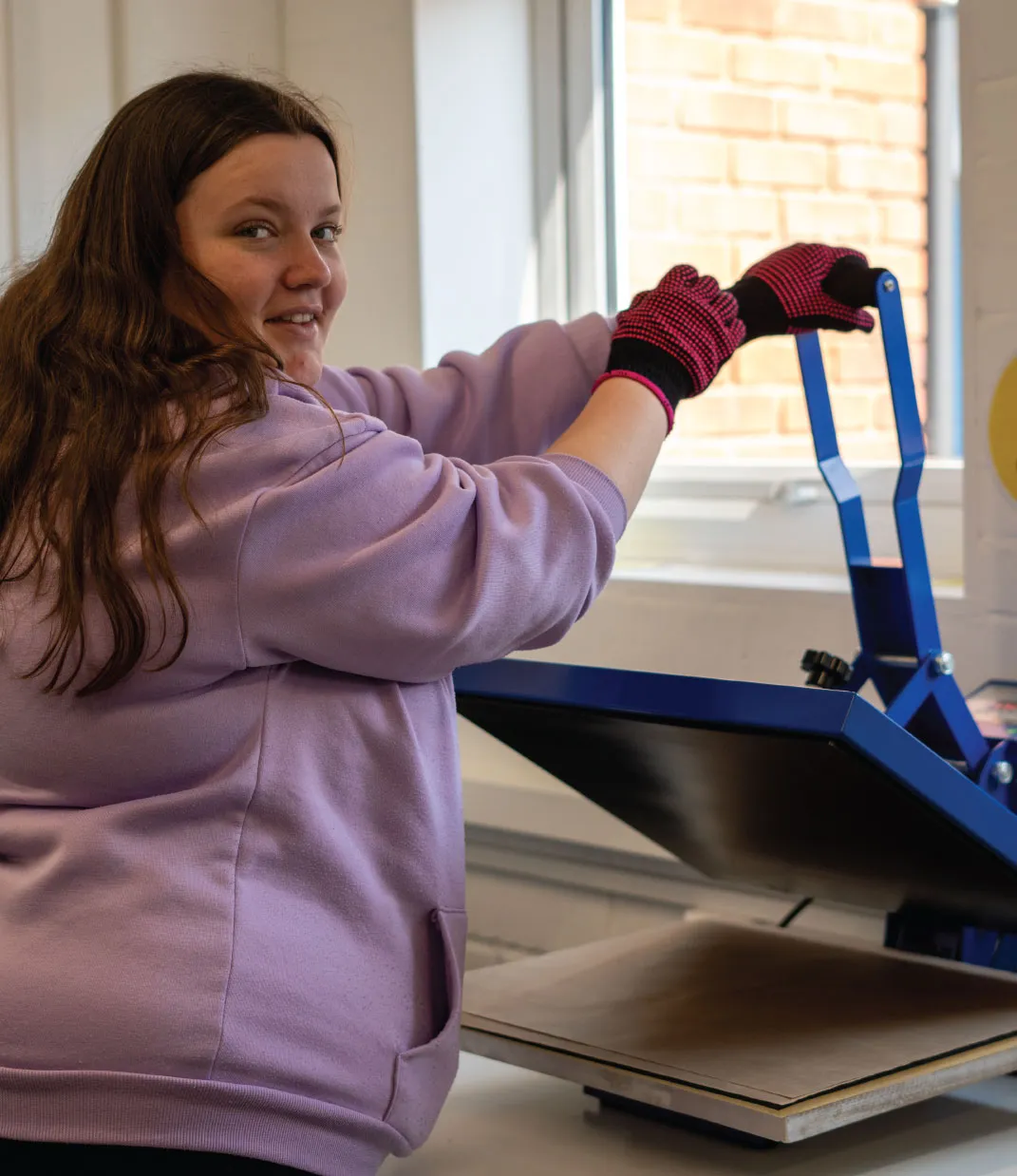 Bridge School Malvern - Student working on heat press in textiles 