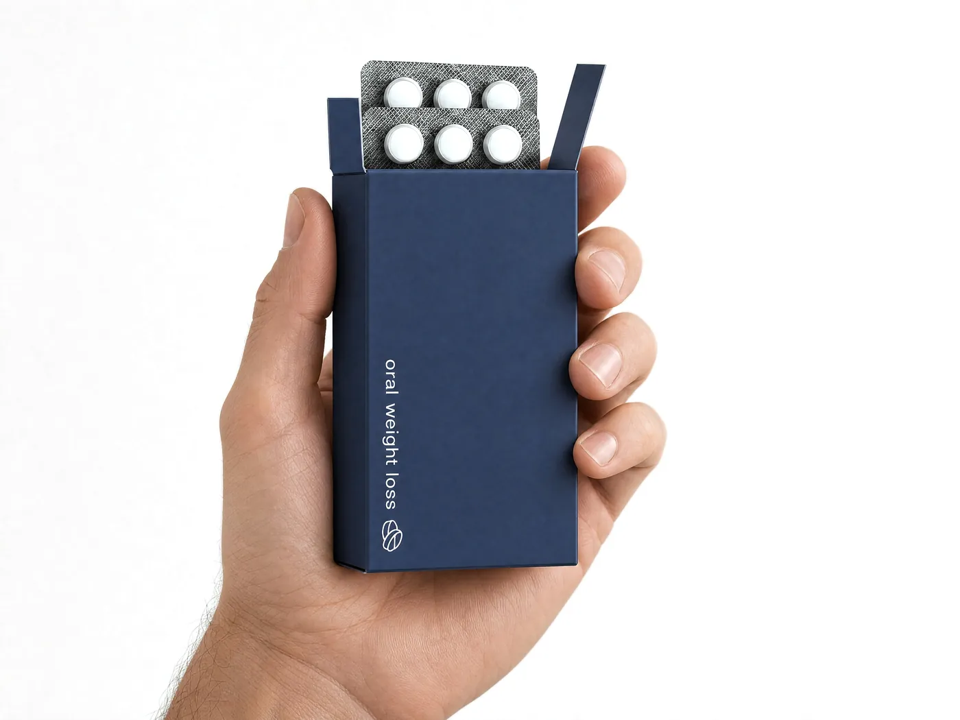 Open HeMed treatment box held in hand, with blister-packed tablets inside