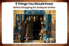 Open antique shop door displaying hanging brass lamps and various vintage items inside and outside.