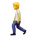 Cartoon character walking with a blue suitcase and wearing a yellow shirt and purple pants.