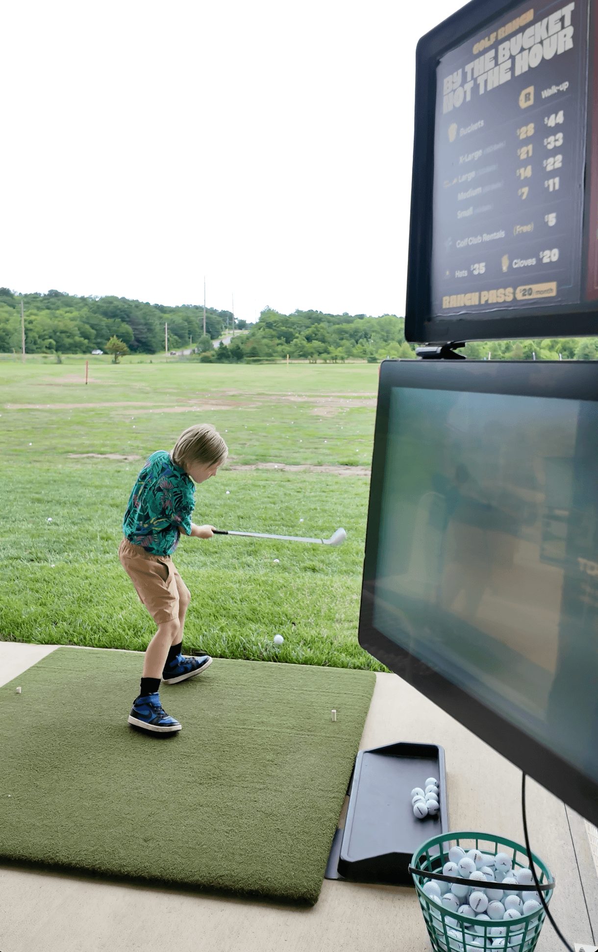 Junior golfer at a Golf Ranch bay with tracking screen