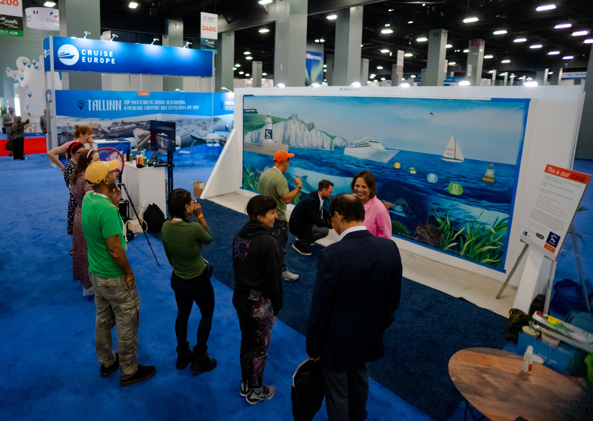 The Port of Dover booth at Seatrade in Miami, with a mural painted live by local artists.