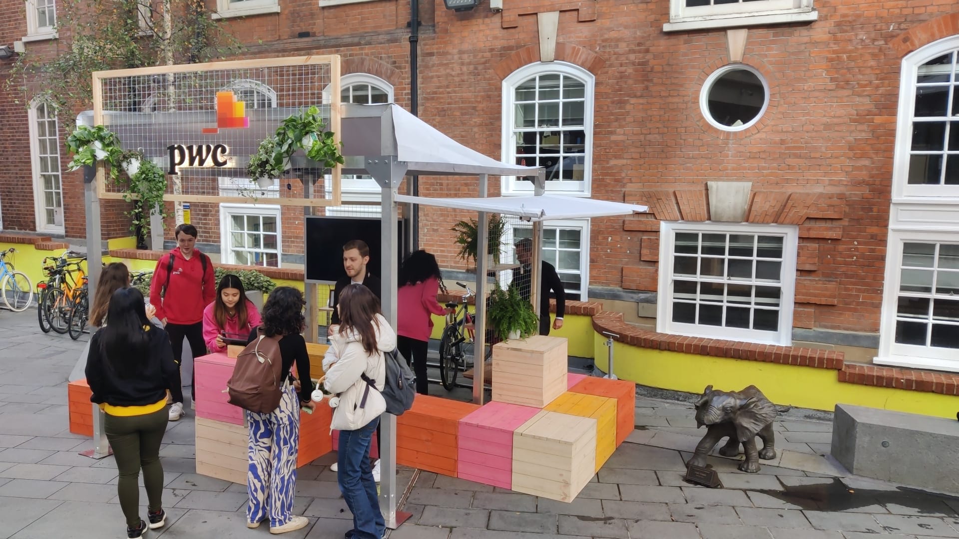 A PwC recruitment parklet on a UK university campus, in use by students.