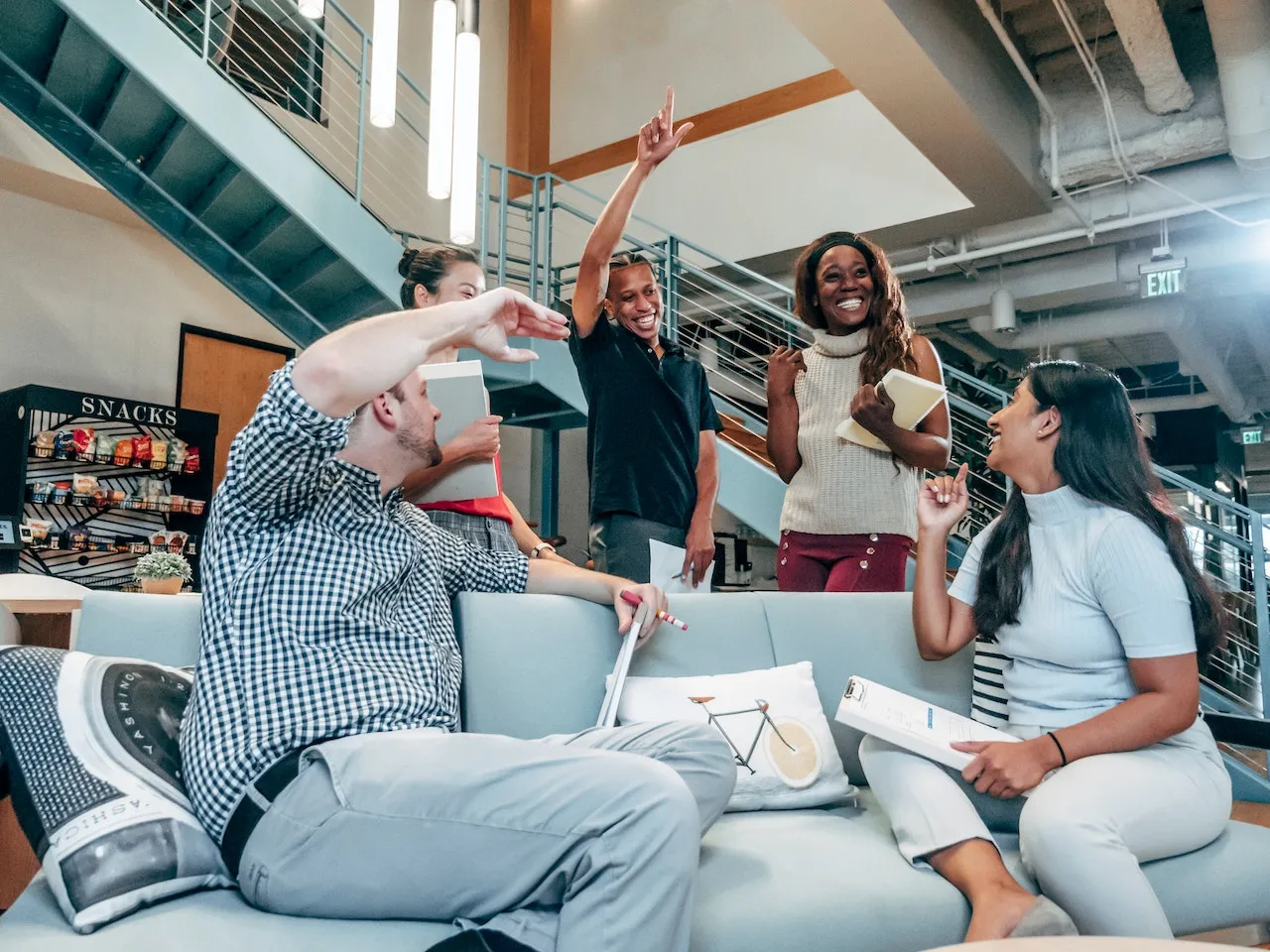 A team sharing a laugh in the office lounge