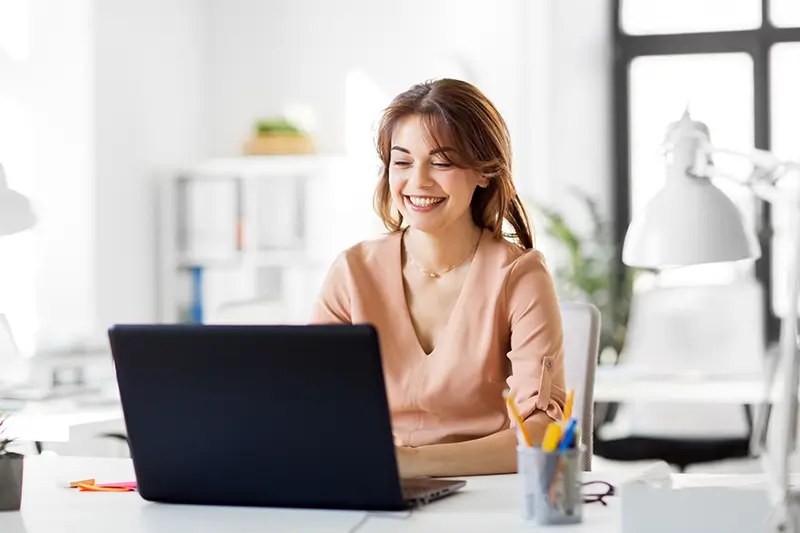 Happy BPO professional working in bright modern office showcasing world-class customer service talent for US businesses