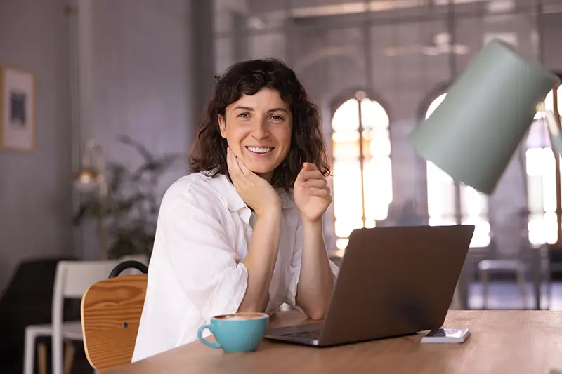 BPO professional enjoying coffee break in stylish office showcasing work-life balance of global remote team members