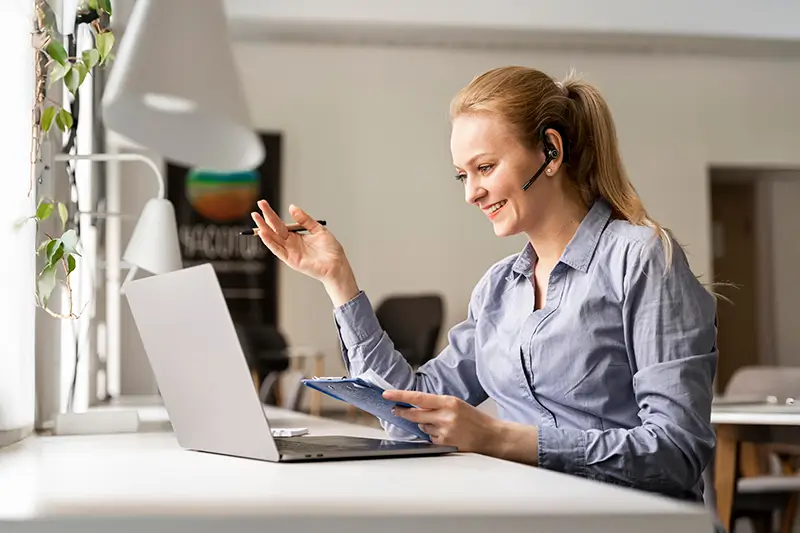 Happy remote closer with headset on video call showcasing professional customer service and world-class remote sales talent