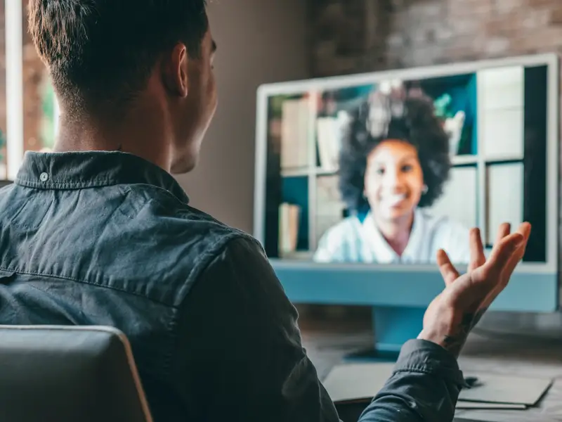 Professional engaging in video call with global team member showcasing remote business development collaboration