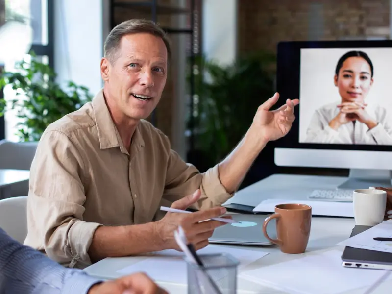 Business leader conducting virtual meeting with international talent through Somewhere's remote work solutions