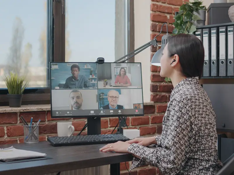 Remote team leader conducting virtual meeting with diverse international colleagues via video conference