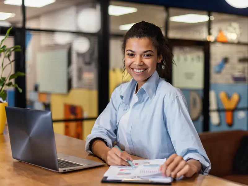 Smiling business professional working on talent management solutions connecting diverse global teams