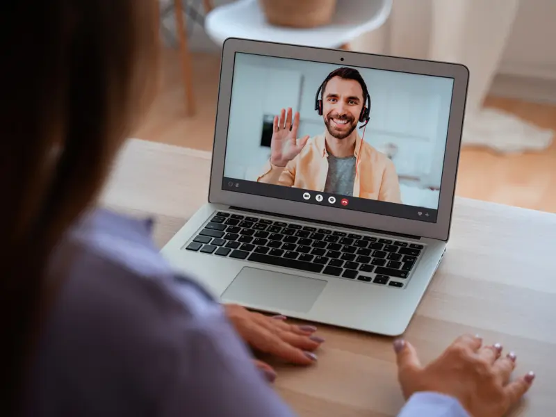 Professional conducting virtual interview with remote candidate showcasing global talent recruitment through video call