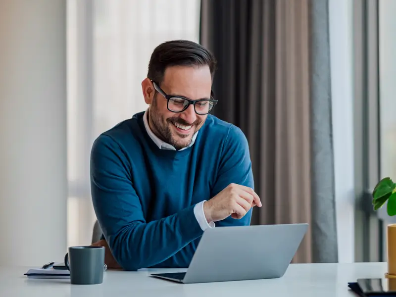 Professional remote team leader smiling during virtual collaboration session representing successful distributed workforce